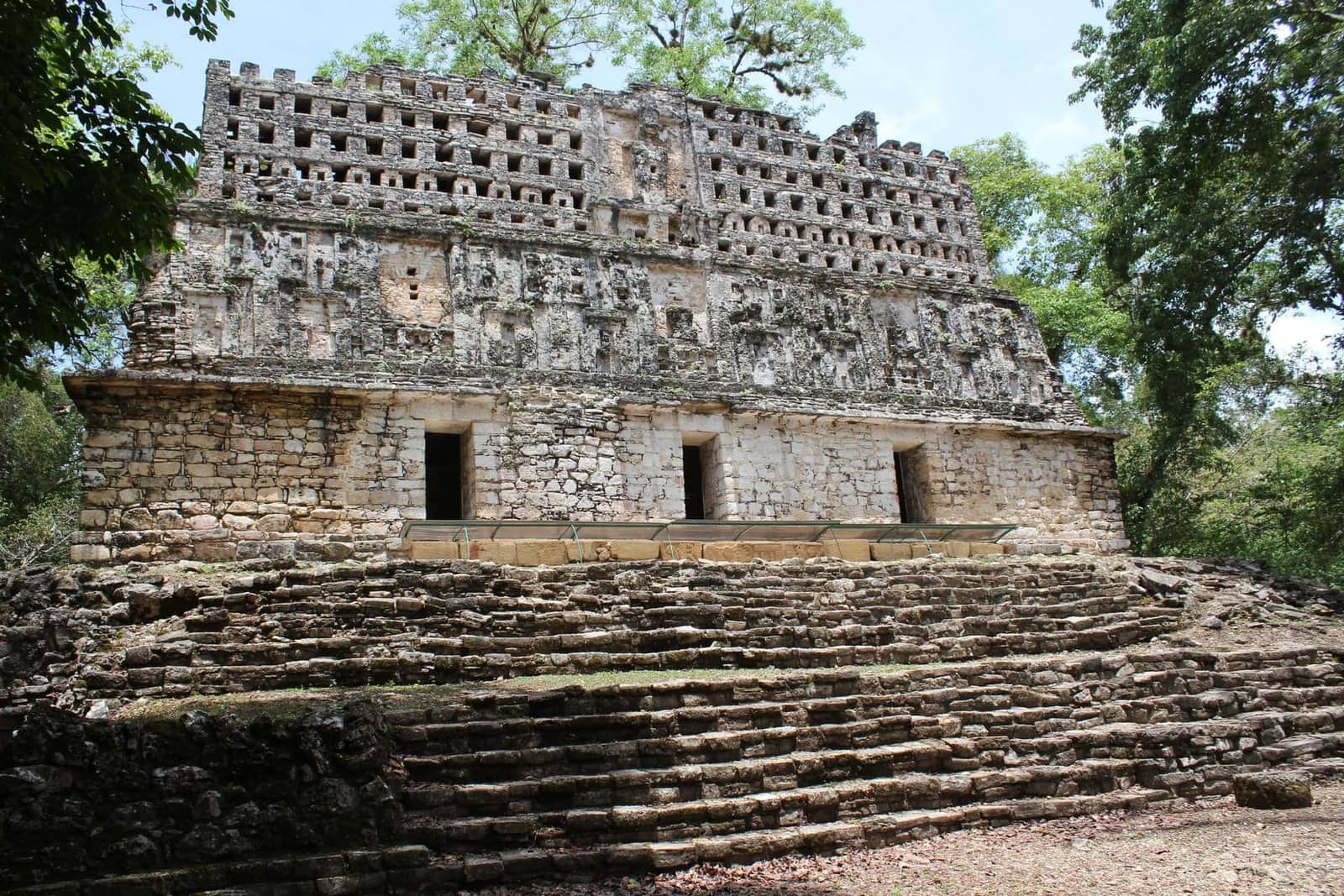 Structure 33 at Yaxchilán, with its pierced roof comb, rising above the Chiapas rainforest